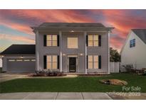 Two-story house with a white exterior, columns, and a two-car garage at 6518 Afterglow Dr, Indian Trail, NC 28079