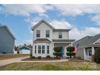 Two-story white house with landscaping and American flag at 748 Inwood Hill Dr, Gastonia, NC 28056