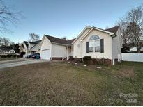 Brick ranch home with attached garage and landscaping at 959 Avery Ct, Concord, NC 28025