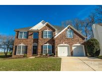 Brick two-story house with a two-car garage and landscaped lawn at 13234 Hidcote Ct, Huntersville, NC 28078