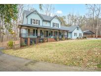 Two-story house with wrap-around porch, landscaped yard, and driveway at 161 Moore Haven Dr, Salisbury, NC 28147