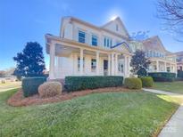 Two-story house with a front porch and manicured lawn at 2219 Lochview St, Pineville, NC 28134