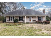 Ranch home with front porch, mature landscaping, and a spacious yard at 3219 Monte Dr, Monroe, NC 28110