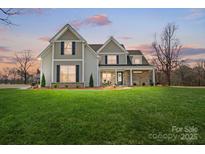 Beautiful two-story home boasting a spacious front yard and craftsman-style details at 3428 Greene Rd, Monroe, NC 28110