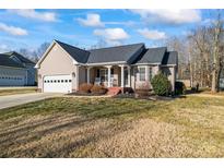 Tan house with gray roof, attached garage, and a front porch at 489 Maple Ridge Cir, Salisbury, NC 28147