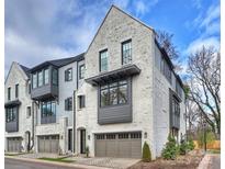 Charming townhome exterior featuring painted brick, modern windows, and a two-car garage at 6133 Berryhill Towns Dr, Charlotte, NC 28270