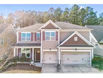 Charming two-story home featuring a two car garage, neutral colored exterior, and a cozy front porch at 79031 Ridgehaven Rd, Lancaster, SC 29720