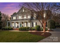 Charming home with a large front porch, manicured landscaping, and elegant architectural details at 110 Lynbrook Dr, Davidson, NC 28036