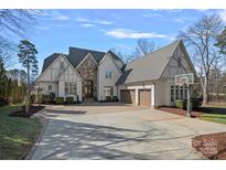 Two-story house with stone accents, three-car garage, and basketball court at 20517 Queensdale Dr, Cornelius, NC 28031