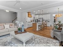 Modern kitchen with white cabinets, gas cooktop and island at 272 Gilead Rd, Huntersville, NC 28078