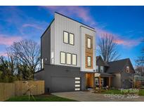 Striking modern home featuring a two-car garage and a mix of siding and wood accents at 3132 Carol Ave, Charlotte, NC 28208