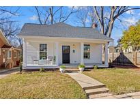 Charming white home featuring a cozy front porch with classic columns and a walkway leading to the entrance at 506 S Church St, Salisbury, NC 28144