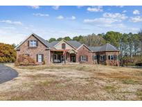 Brick home with stone accents, and a large front yard at 5645 White Store Rd, Wingate, NC 28174