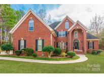 Brick two-story house with a landscaped yard and driveway at 606 Elmhurst Dr, Fort Mill, SC 29715