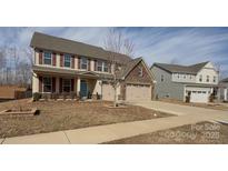 Two-story house with attached garage and landscaping at 7405 Bosson Sw St, Concord, NC 28025