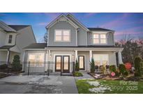 Two-story home with gray siding, double doors, and a black fence at 128 Shay Crossing Rd, Salisbury, NC 28146