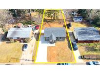 Newly renovated house with a large yard, driveway and detached shed at 4513 Munsee St, Charlotte, NC 28213