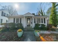 Charming home with classic columns, black shutters, and colorful flowerpots at 531 Elm St, Salisbury, NC 28144