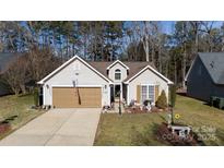 Tan two-car garage and charming front yard at 630 Montgomery Dr, Rock Hill, SC 29732