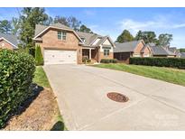 Brick house with 2-car garage, and well-manicured lawn at 7853 Ballentrae Pl, Stanley, NC 28164