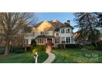 Charming brick home with manicured lawn and walkway leading to an inviting front entrance at 115 Union Chapel Dr, Mooresville, NC 28117