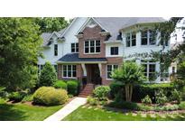 Charming brick and white two-story home with manicured lawn and mature landscaping at 115 Union Chapel Dr, Mooresville, NC 28117