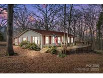 Charming ranch home with a deck, nestled on a wooded lot at 11745 Stokes Ferry Rd, Gold Hill, NC 28071