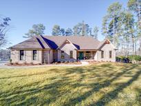 Brick home with a large front yard and walkway at 168 Tanglewood Cv, Belmont, NC 28012