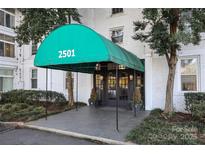 Inviting building entrance features a grand awning with prominent address numbers, promising easy identification at 2501 Roswell Ave # 303, Charlotte, NC 28209