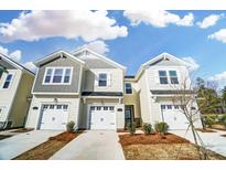 Charming townhomes featuring attached garages and welcoming curb appeal with manicured landscaping under a bright sky at 252 Laura Elizabeth Ln, Clover, SC 29710