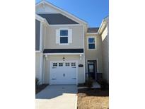 Beige two-story townhome with white garage door and landscaping at 252 Laura Elizabeth Ln, Clover, SC 29710