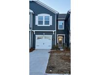 Modern two-story townhome with gray siding, white garage door, and landscaping at 268 Laura Elizabeth Ln, Clover, SC 29710