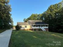 One-story house with a front porch and driveway at 475 Cornerstone Dr, Taylorsville, NC 28681