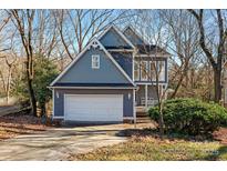 Gray two-story house with attached garage and landscaped yard at 6017 Millbury Ct # 16, Charlotte, NC 28211