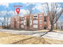 Two story brick condo building featuring balconies and manicured landscaping at 780 N Davidson St, Charlotte, NC 28202