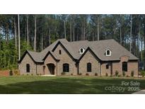 Beautiful single-story brick home featuring arched entry, dormer windows and a well-manicured lawn at 7941 Gulf Creek Rd, Lancaster, SC 29720