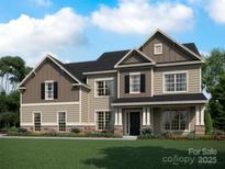 Charming two-story home featuring a well-manicured lawn and a welcoming front porch and multi-tone color scheme at 1008 Marquis Hills Dr # Mas0106, Fort Mill, SC 29715