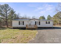 Charming single-story home featuring a welcoming front porch and a well-maintained lawn at 145 Morcroft Ln, Cleveland, NC 27013