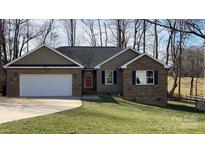 Charming single-story home features a brick facade, attached garage, and well-maintained front yard at 1790 Kathy St, Newton, NC 28658