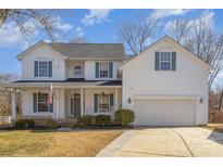 Charming two-story home featuring a welcoming front porch, attached garage, and manicured landscaping at 4763 Brockton Nw Ct, Concord, NC 28027