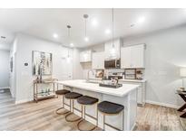 Bright kitchen features an island with seating, quartz countertops and stainless steel appliances at 608 Cassidy Ct, Clover, SC 29710