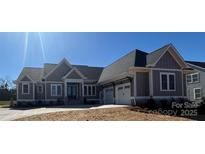 Beautiful single-story home showcasing a neutral color palette, inviting facade, and attached three-car garage at 6098 Ballard Rd, Denver, NC 28037