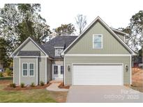 Two-story house with light green siding, white trim, and a two-car garage at 136 Autumn Blaze Rd, China Grove, NC 28023