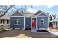 Newly built home with blue siding, red door, and landscaped yard at 140 3Rd Se Ave, Hickory, NC 28602