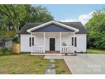 Charming exterior of a home with a inviting front porch and well-maintained lawn at 211 Brooklyn Ave, Lancaster, SC 29720
