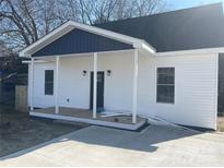 Charming, newly renovated one-story home with a covered porch, white siding and black accents at 211 Brooklyn Ave, Lancaster, SC 29720