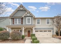 Traditional home showcasing detailed trim, a cozy porch, and an attached two-car garage at 2201 Bluebell Way, Tega Cay, SC 29708