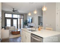 Open concept kitchen with island seating overlooking the living room at 2401 Euclid Ave # 110, Charlotte, NC 28203