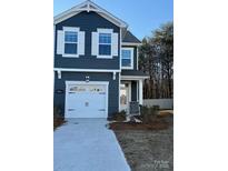 Two-story home with gray siding, white garage door, and landscaping at 264 Laura Elizabeth Ln, Clover, SC 29710