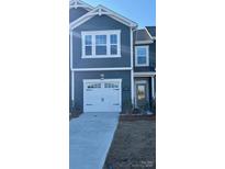 Gray two-story townhome with white garage door and landscaping at 276 Laura Elizabeth Ln, Clover, SC 29710